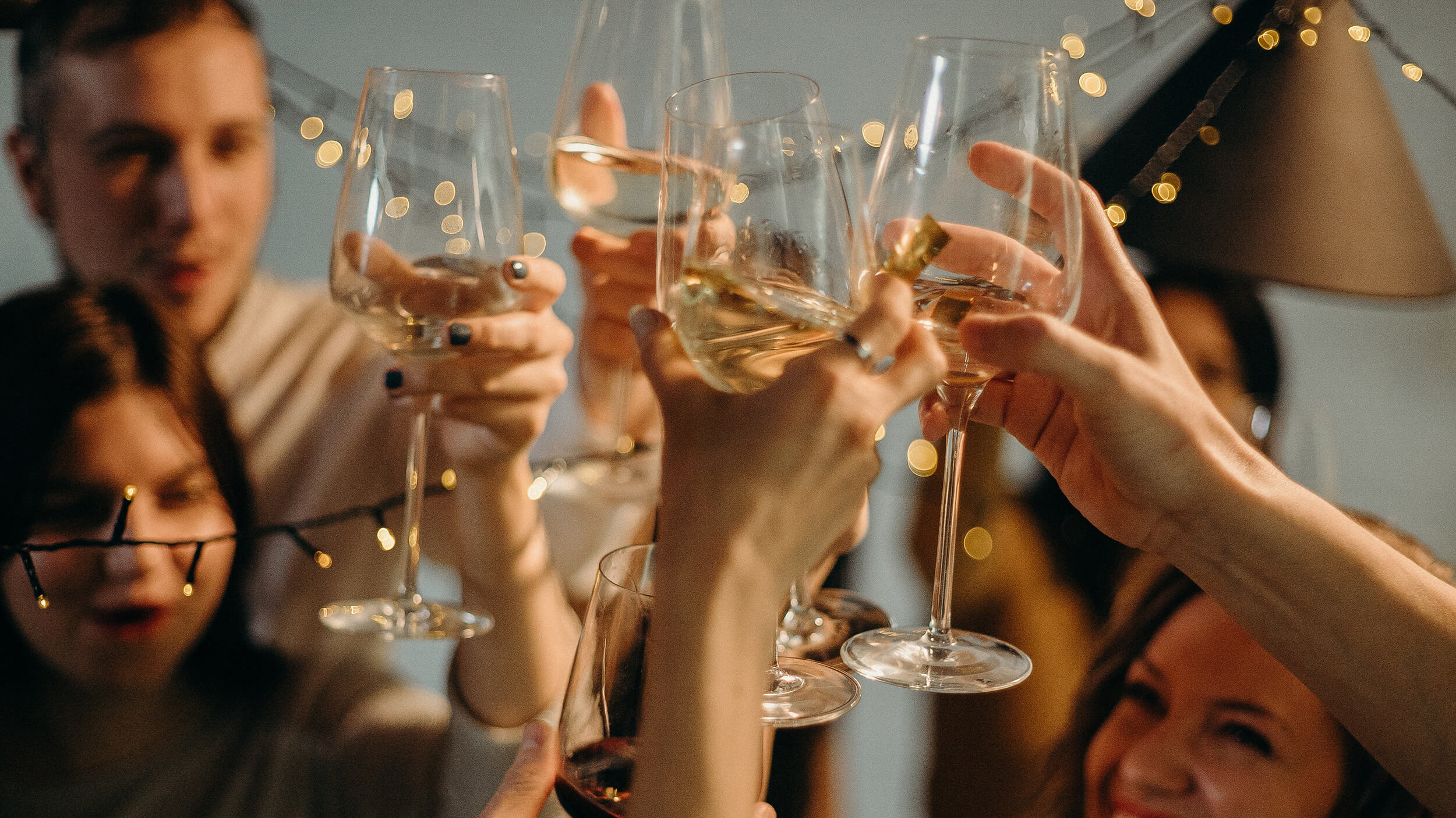 group of people toasting with sparkling wine