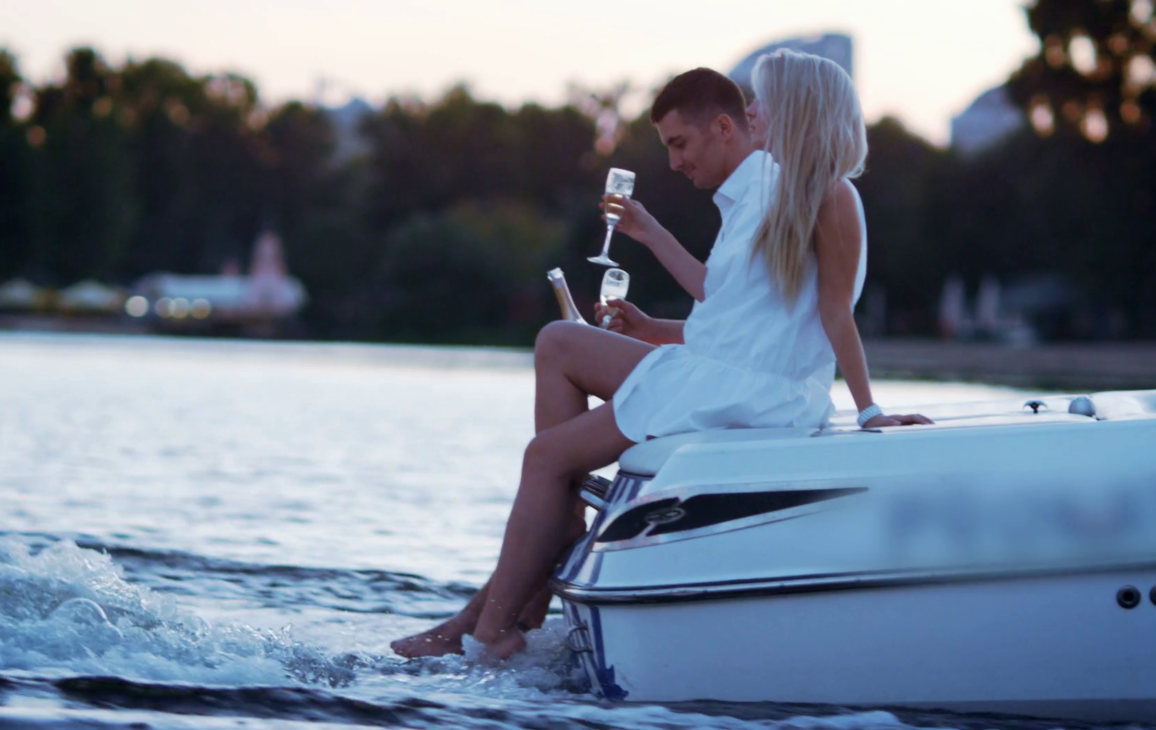 couple drinking sparkling wine on boat